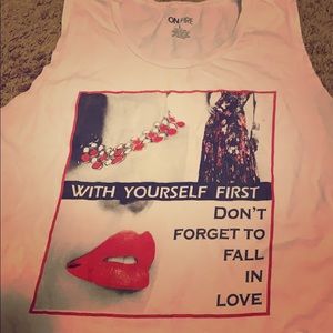 A white 100% cotton t-shirt with no sleeves